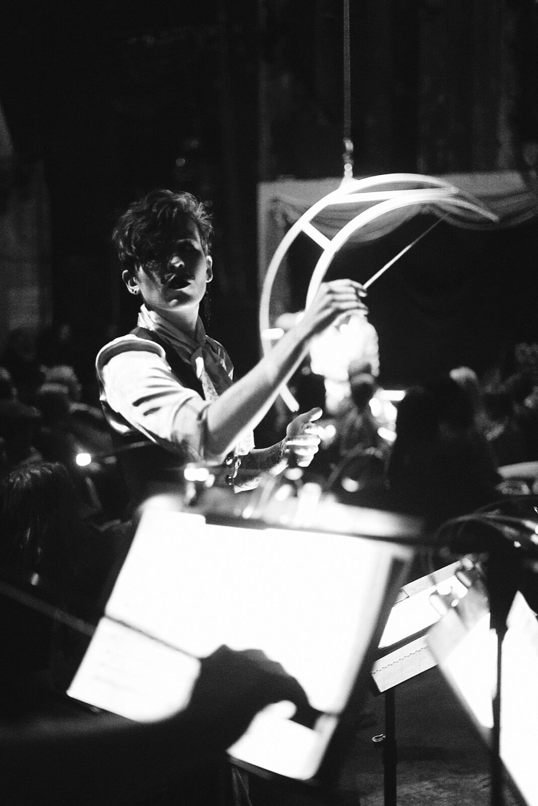 Whitney George conducting, black-and-white stage portrait