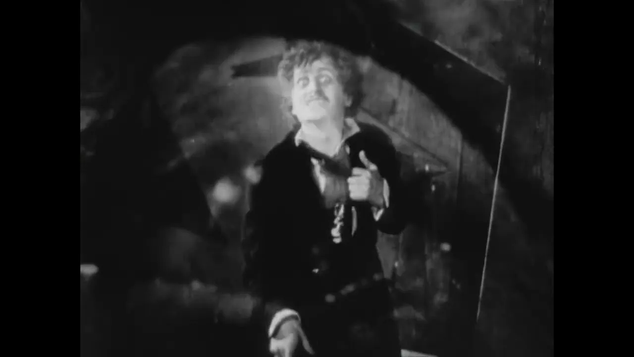 A startled man standing beneath a stone arch in The Tell-Tale Heart