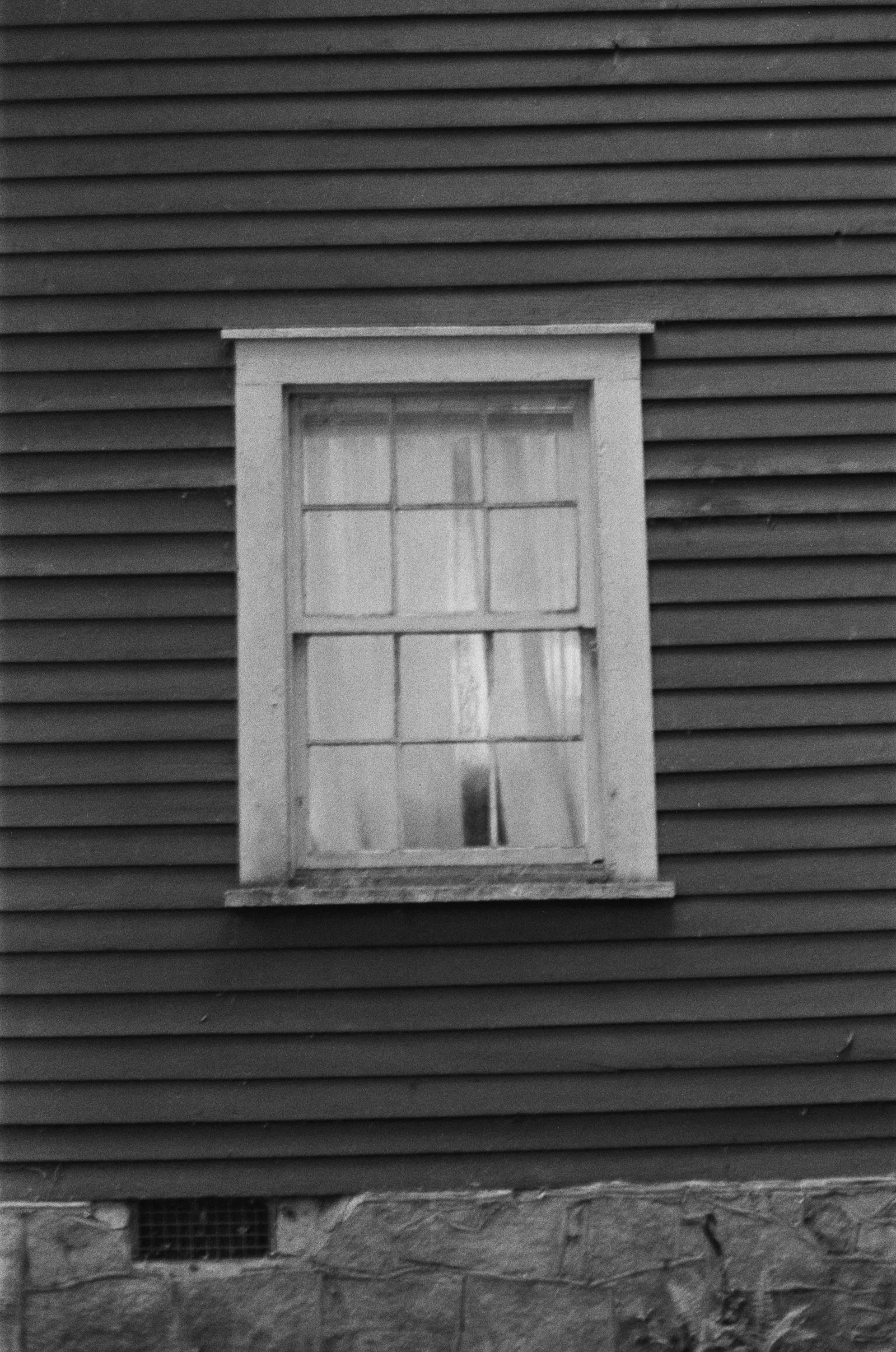 Black-and-white field photograph returned as Frame 4, a window from inside.